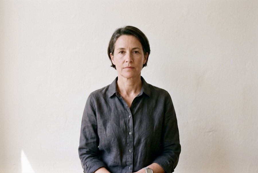 A woman in her fifties looking directly at the camera, composed and unhurried.